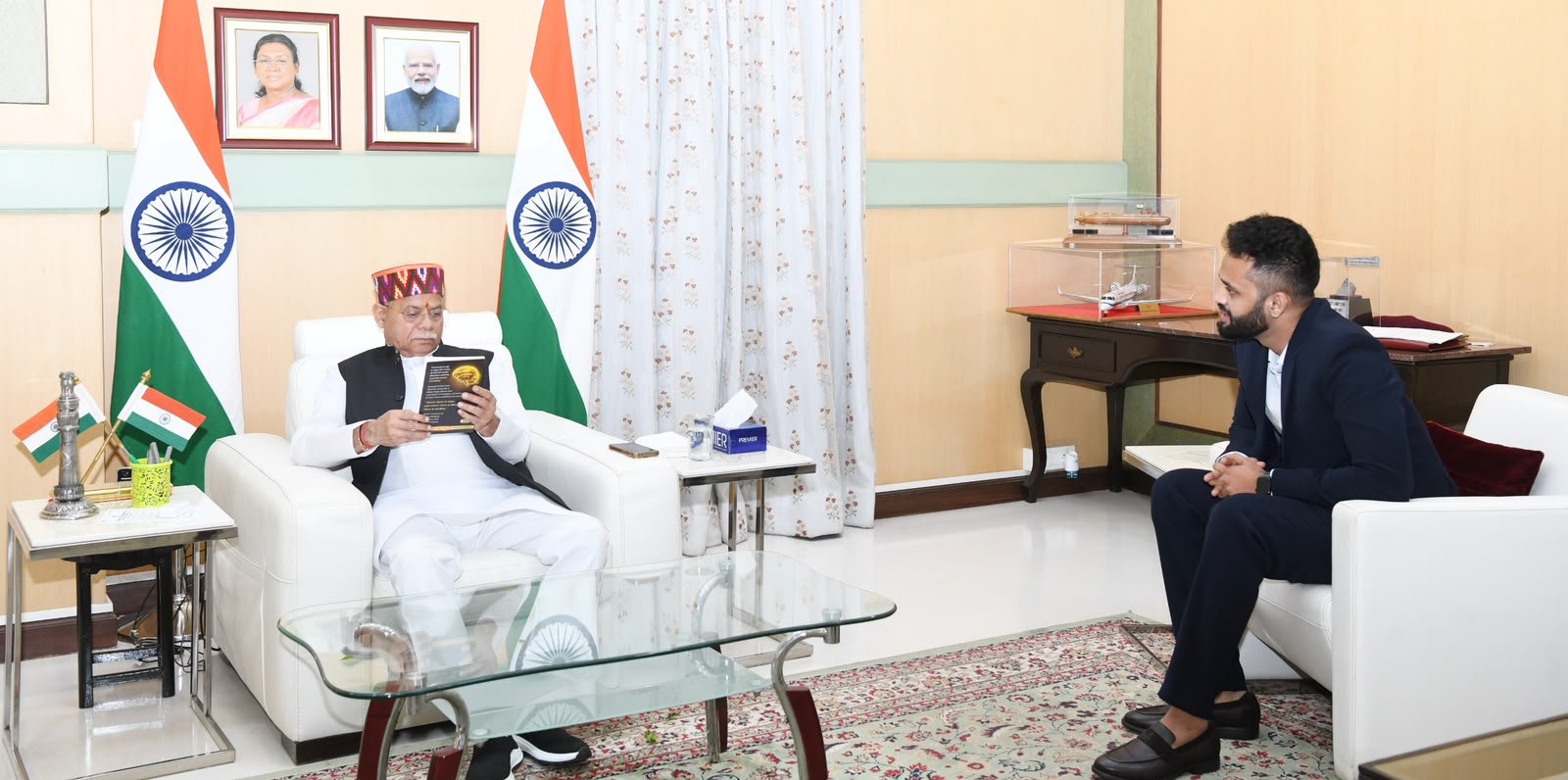 The Hon'ble Governor of Telangana with a copy of 100 Stories of Healing