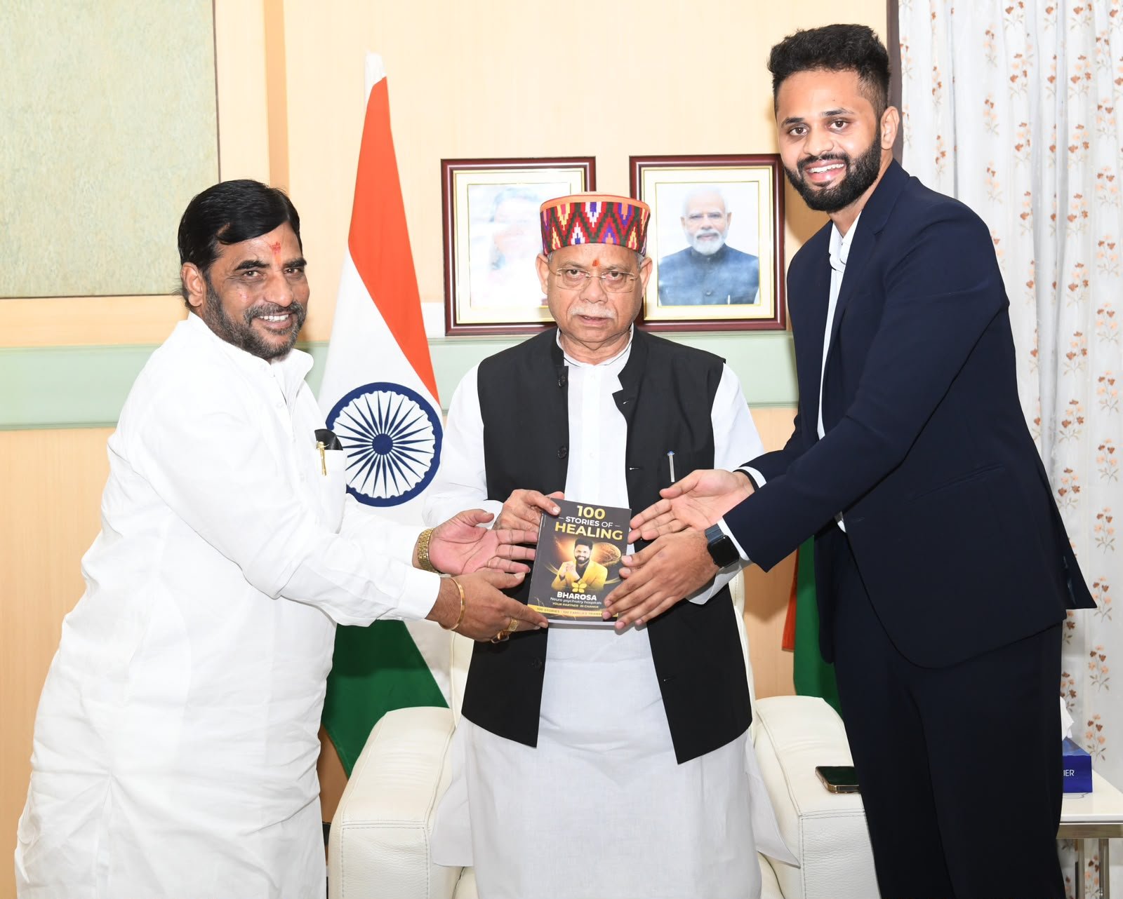 Dr. Uday Kiran presenting the book 100 Stories of Healing to the Hon'ble Governor of Telangana