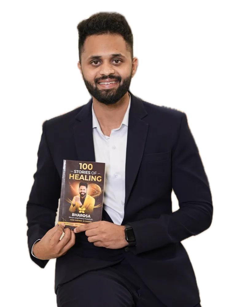 Dr. Uday Kiran holding his book 100 Stories of Healing